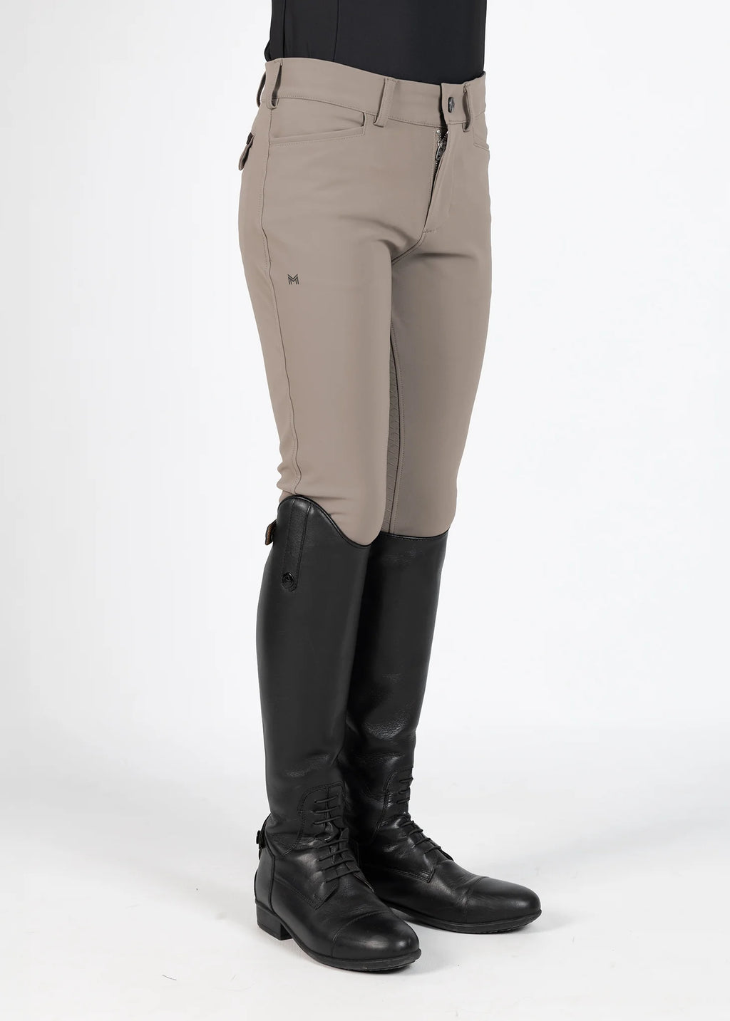 Beige riding pants with black riding boots on a white background